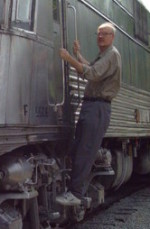 John Byers hanging on a train